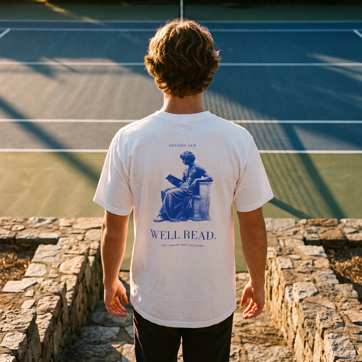 White | Lifestyle | WEEKEND HEIR Well Read Tee in White at the tennis court, back print showing