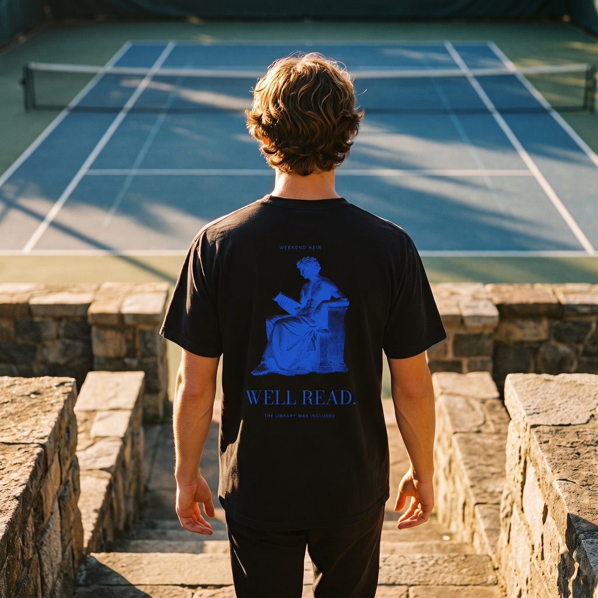 Black | Lifestyle | WEEKEND HEIR Well Read Tee in Black at the tennis court, back print showing